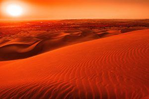 orange-sunset-over-wavy-sand-dune-landscape